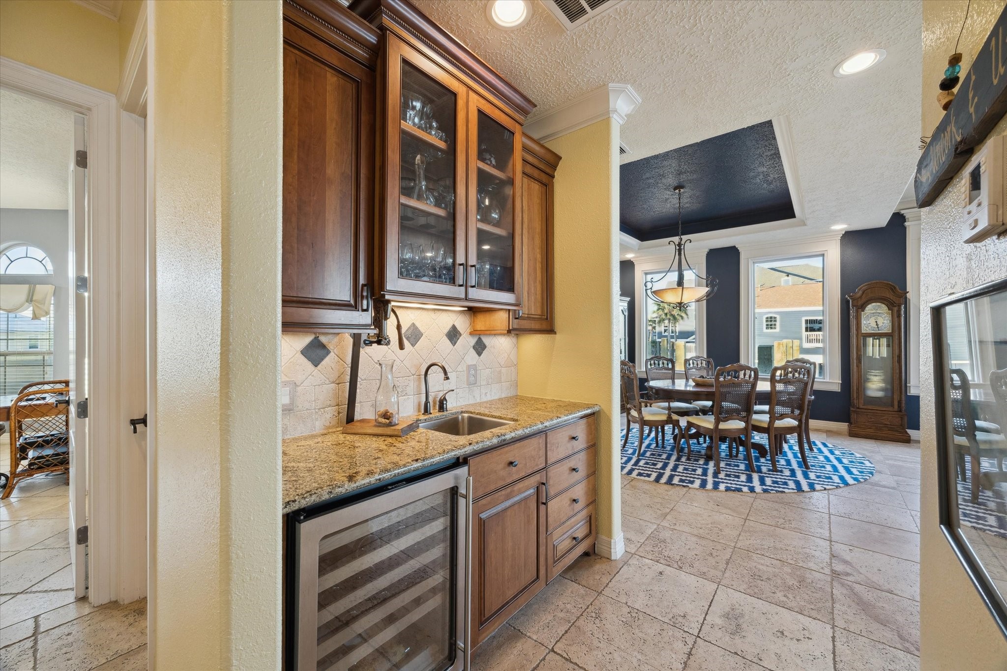 1406 Todville Road Seabrook, TX 77586 - Photo 26 of 50 CONVENIENT BUTLERS' PANTRY AND WET BAR WITH WINE REFRIGERATOR SITS PERFECTLY BETWEEN THE DINING ROOM, DEN AND KITCHEN.