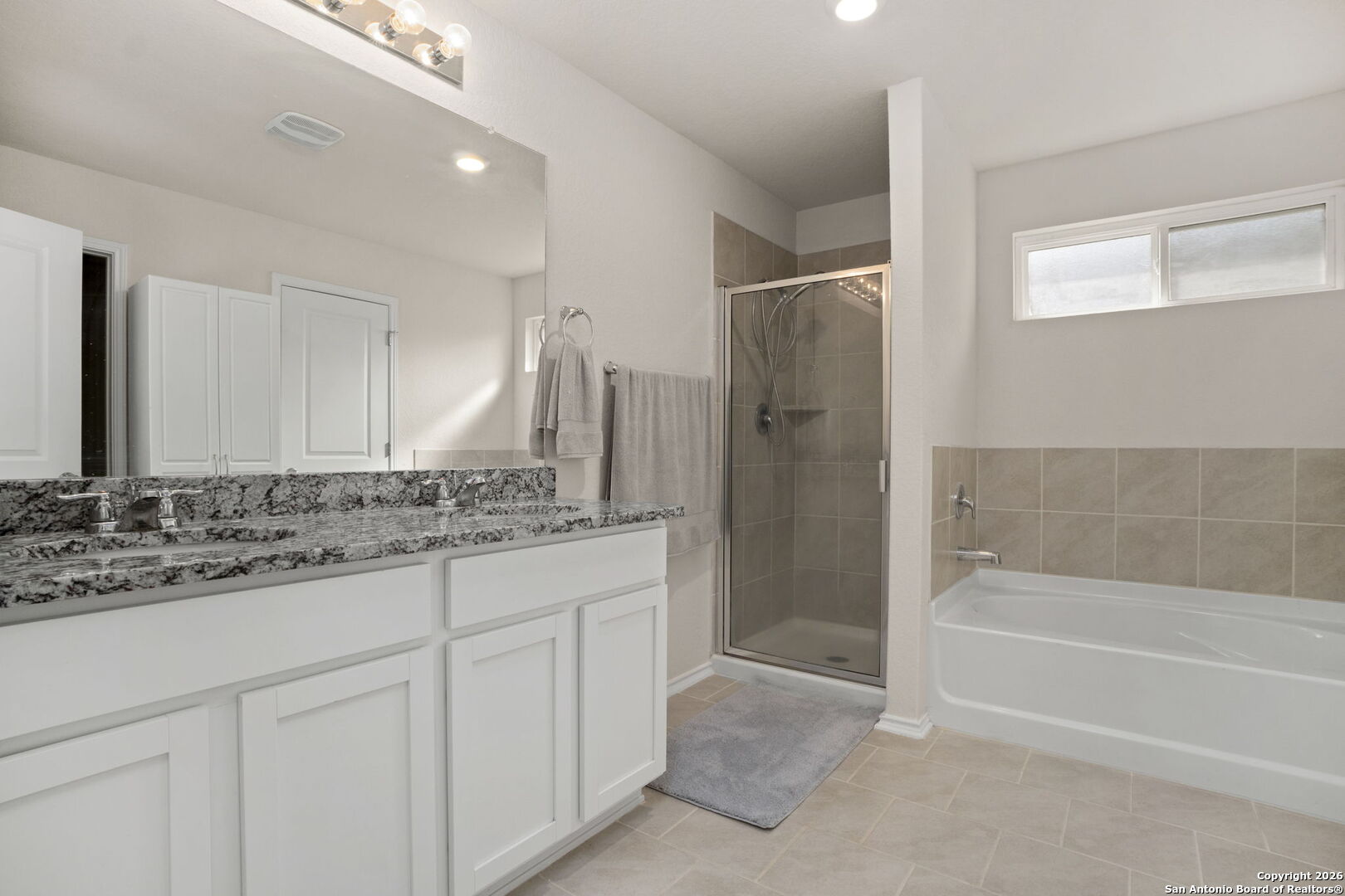 3658 Copper Willow Bulverde, TX 78163 - Photo 15 of 27 a bathroom with a granite countertop sink a mirror and a bathtub