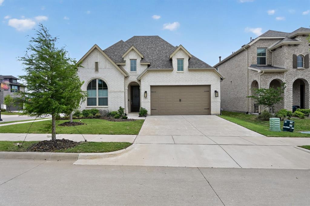 3725 Paradise Way Sherman, TX 75090 - Photo 2 of 26 Elegant brick facade with an arched window and covered entry