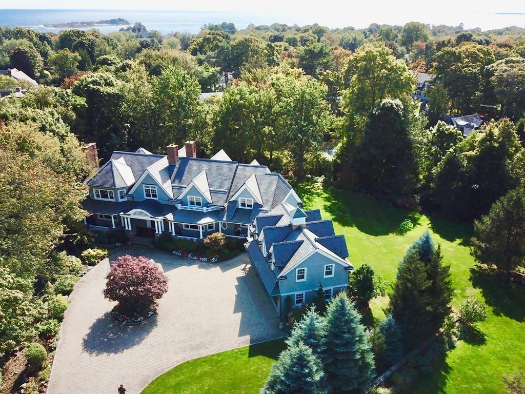 an aerial view of a house with a garden and lake view