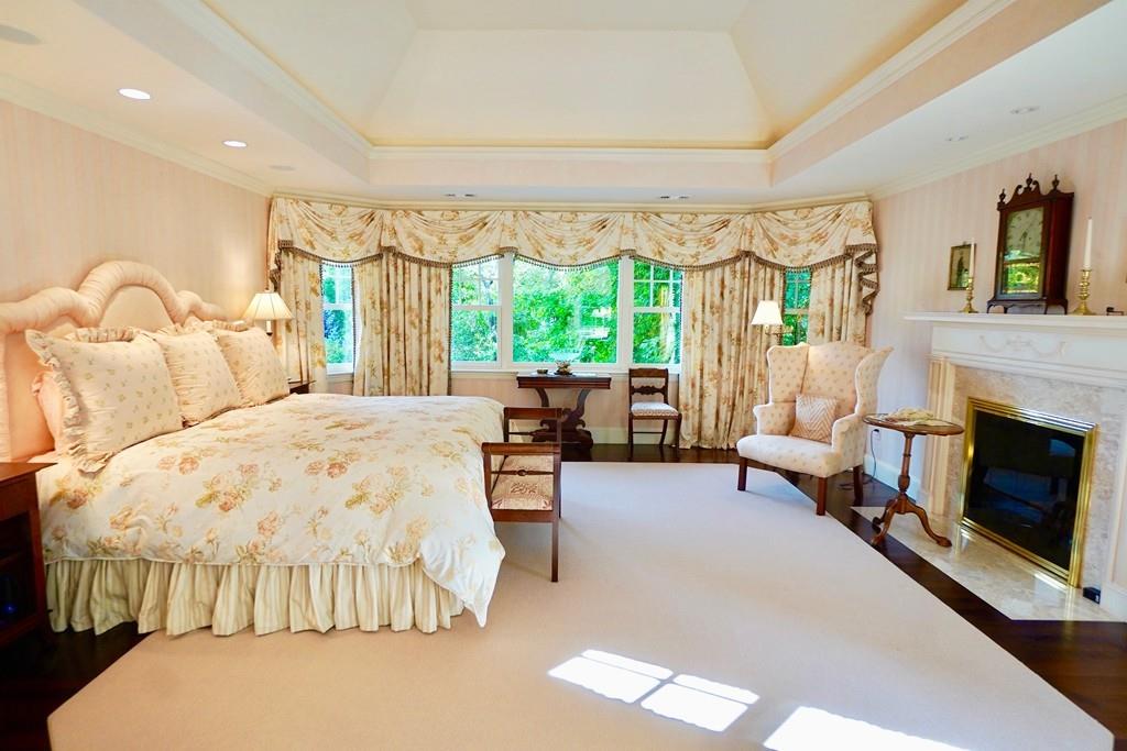 166 Atlantic Avenue Marblehead, MA 01945 - Photo 22 of 36 a bedroom with bed and a fireplace