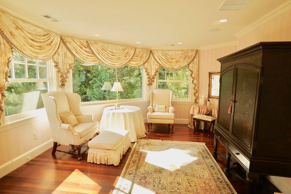 166 Atlantic Avenue Marblehead, MA 01945 - Photo 23 of 36 a living room with patio furniture and a floor to ceiling window