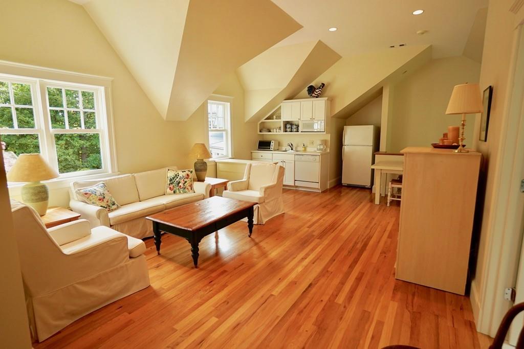 166 Atlantic Avenue Marblehead, MA 01945 - Photo 29 of 36 a living room with furniture a table and wooden floor