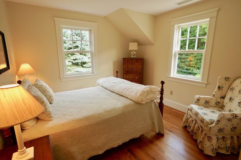 166 Atlantic Avenue Marblehead, MA 01945 - Photo 31 of 36 a bedroom with a bed and wooden floor
