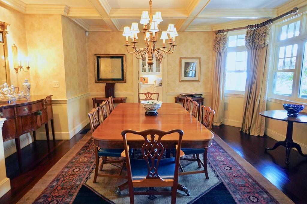 166 Atlantic Avenue Marblehead, MA 01945 - Photo 10 of 36 a dining room with furniture a chandelier and wooden floor