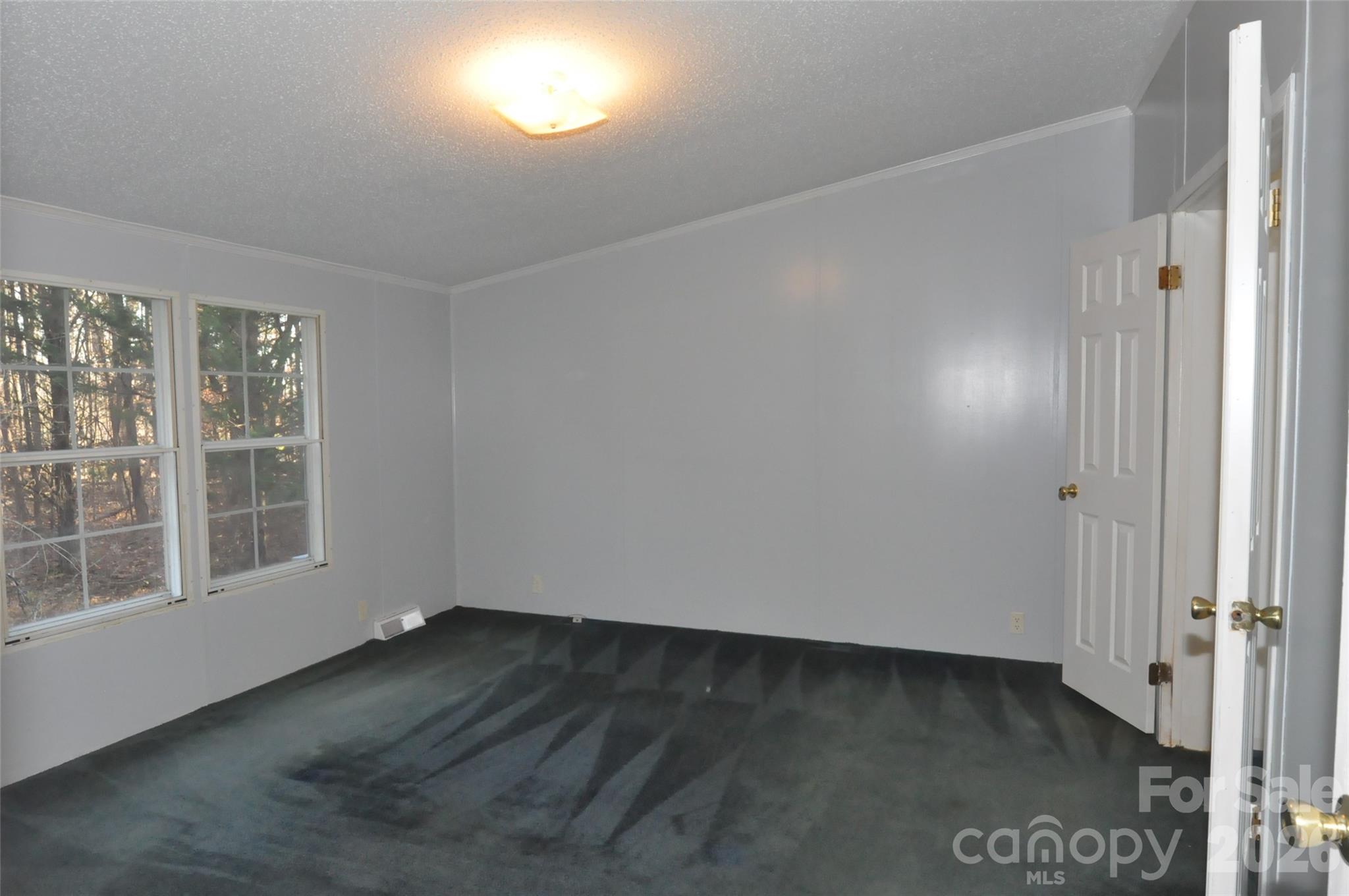 1413 Minter Road Chester, SC 29706 - Photo 13 of 20 an empty room with wooden floor and windows
