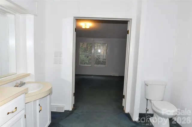 a bathroom with a toilet sink and mirror