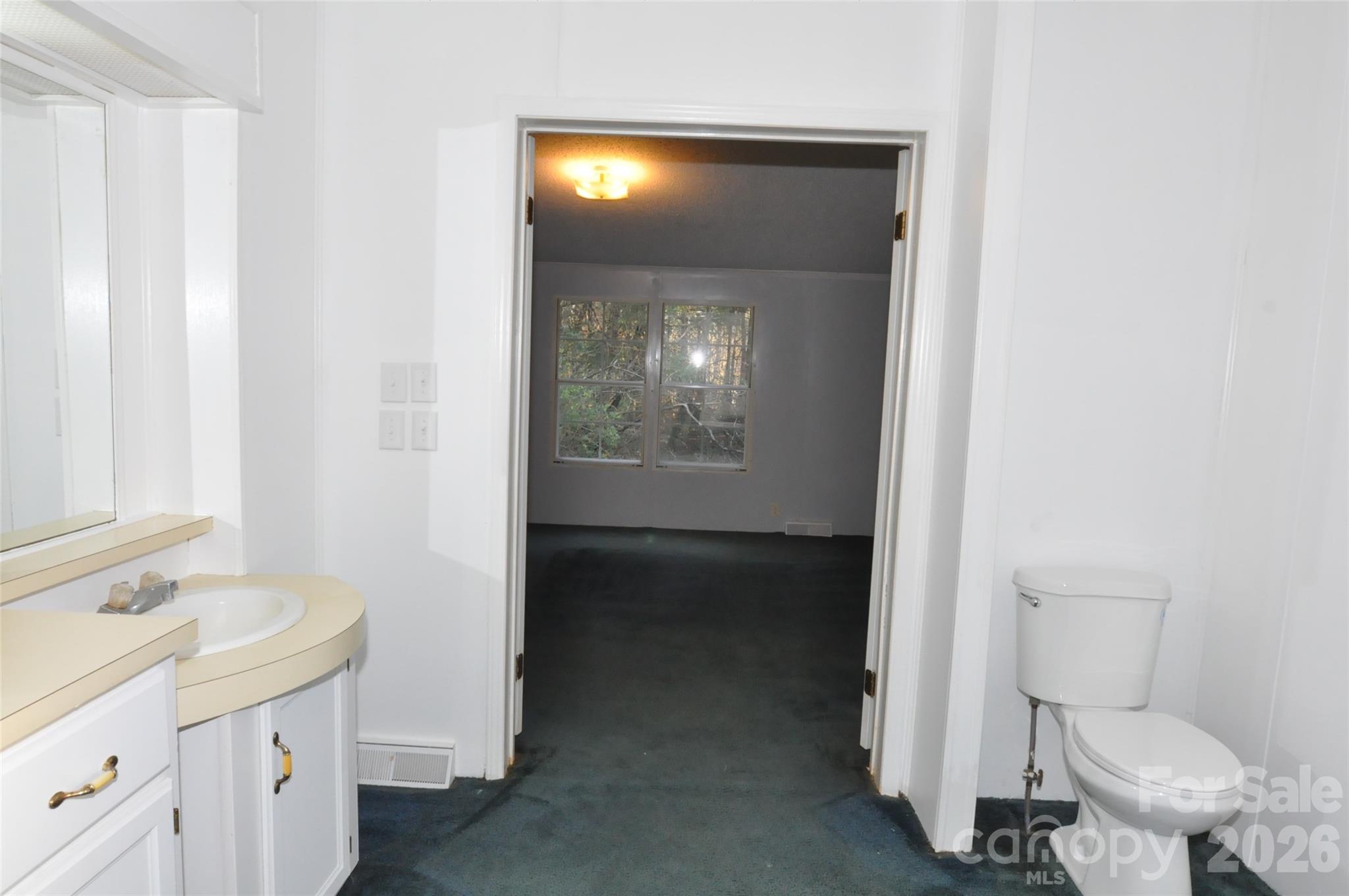 1413 Minter Road Chester, SC 29706 - Photo 16 of 20 a bathroom with a toilet sink and mirror