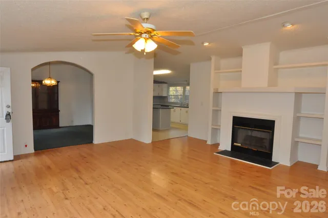 a view of an empty room with a fireplace