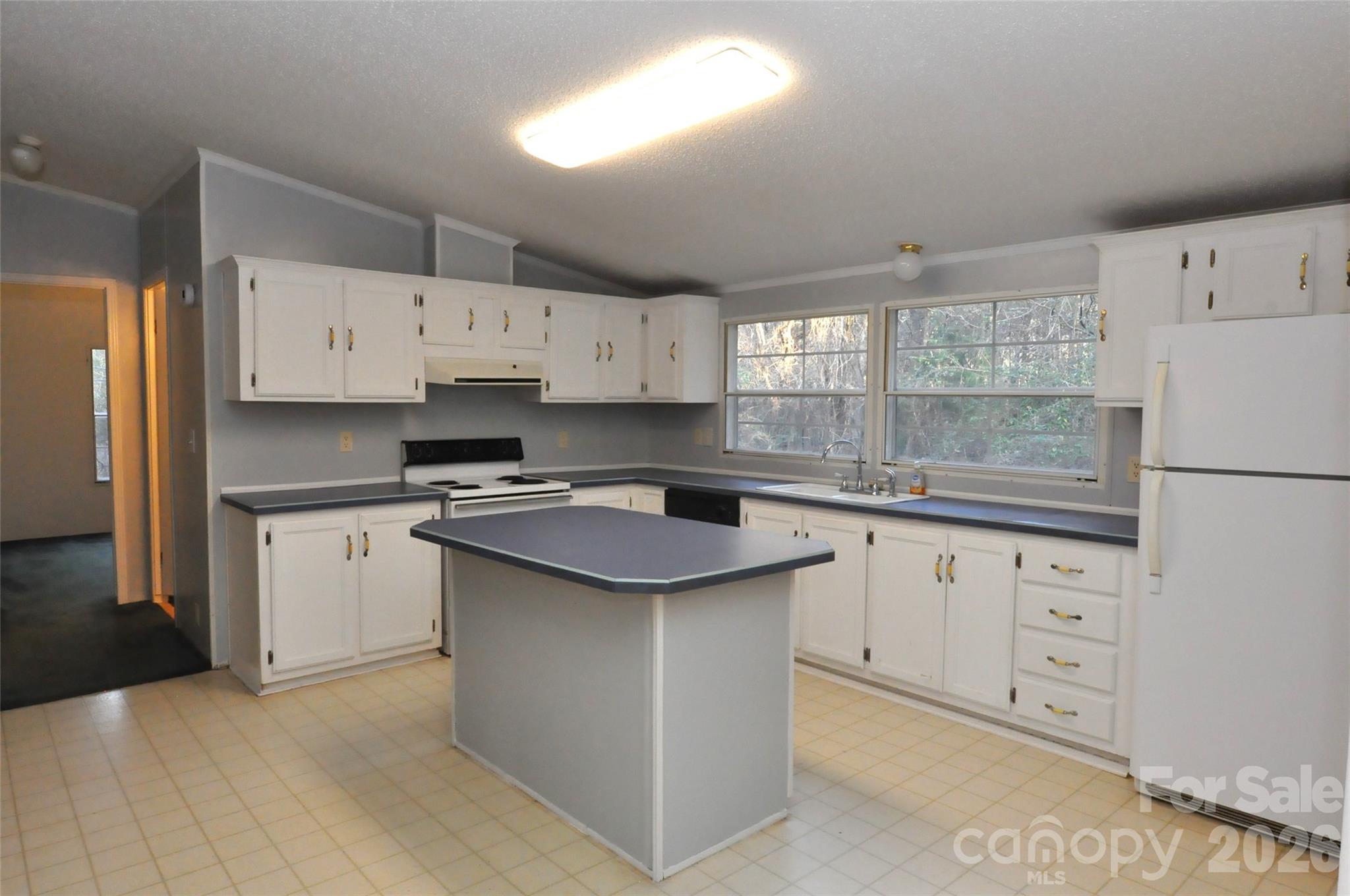 1413 Minter Road Chester, SC 29706 - Photo 6 of 20 a kitchen with granite countertop white cabinets white stainless steel appliances and sink
