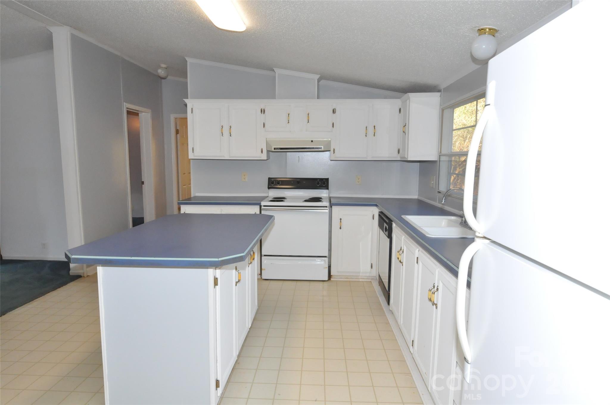 1413 Minter Road Chester, SC 29706 - Photo 8 of 20 a kitchen with kitchen island a stove a sink and a refrigerator