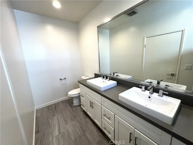 a bathroom with a double vanity sink and mirror
