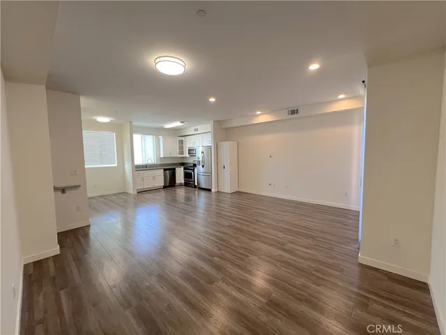 a view of kitchen with furniture and wooden floor