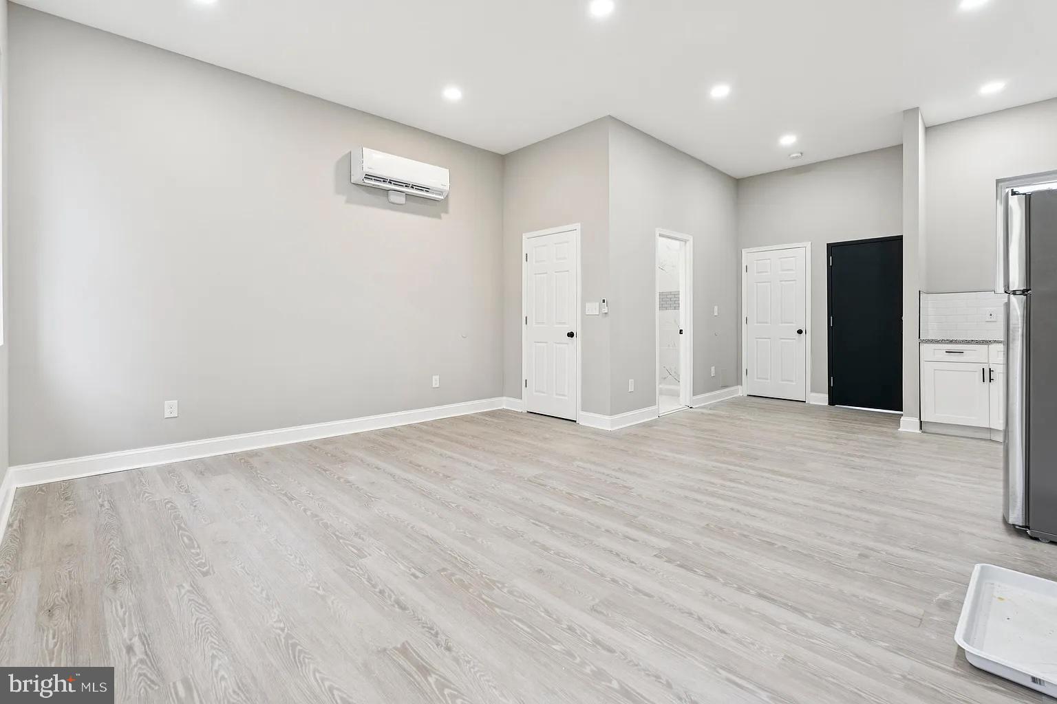 916 North Arlington Avenue, Unit 3 Baltimore, MD 21217 - Photo 4 of 7 a view of an empty room with wooden floor