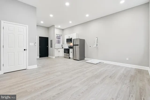 a view of a kitchen with a sink and a refrigerator