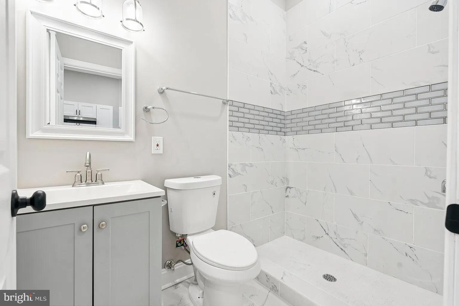 916 North Arlington Avenue, Unit 3 Baltimore, MD 21217 - Photo 7 of 7 a bathroom with a sink toilet and shower