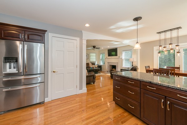 39 R Kimball Road Amesbury, MA 01913 - Photo 11 of 28 a kitchen with stainless steel appliances granite countertop a refrigerator a sink dishwasher a oven and a dining table with wooden floor