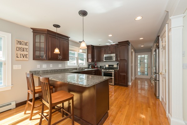 39 R Kimball Road Amesbury, MA 01913 - Photo 12 of 28 a kitchen with stainless steel appliances granite countertop sink microwave and wooden floor