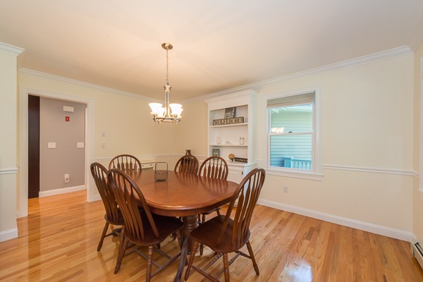 39 R Kimball Road Amesbury, MA 01913 - Photo 14 of 28 a dining room with furniture a chandelier and wooden floor