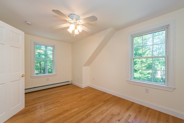 39 R Kimball Road Amesbury, MA 01913 - Photo 19 of 28 a view of an empty room with wooden floor and a window