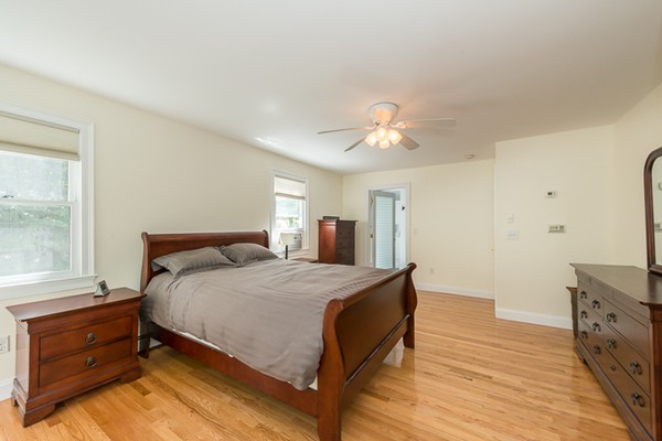39 R Kimball Road Amesbury, MA 01913 - Photo 21 of 28 a bedroom with a bed and a chandelier