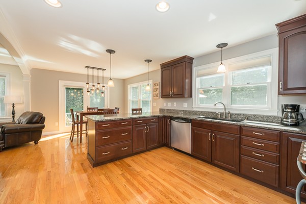 39 R Kimball Road Amesbury, MA 01913 - Photo 10 of 28 a large kitchen with kitchen island granite countertop a sink dishwasher a dining table and chairs with wooden floor