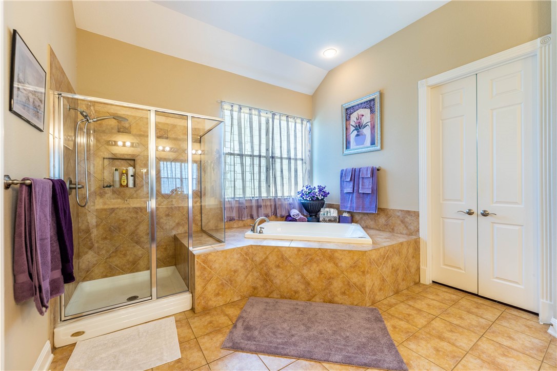 4325 Lago Viento Austin, TX 78734 - Photo 20 of 39 a bathroom with a tub shower and mirror