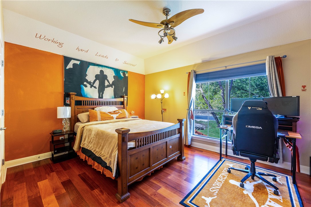 4325 Lago Viento Austin, TX 78734 - Photo 26 of 39 a spacious bedroom with a bed and a desk