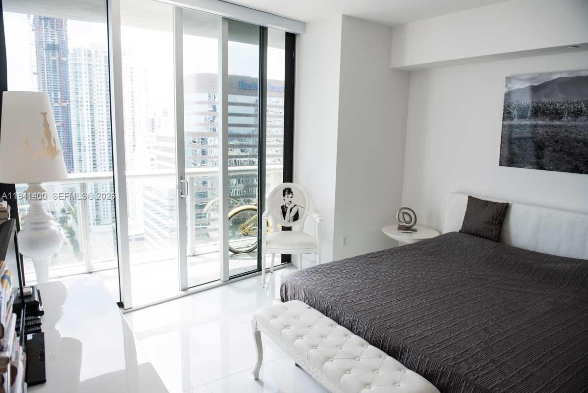 495 Brickell Avenue, Unit 3805 Miami, FL 33131 - Photo 11 of 18 a bedroom with a large bed and a large window with outer view