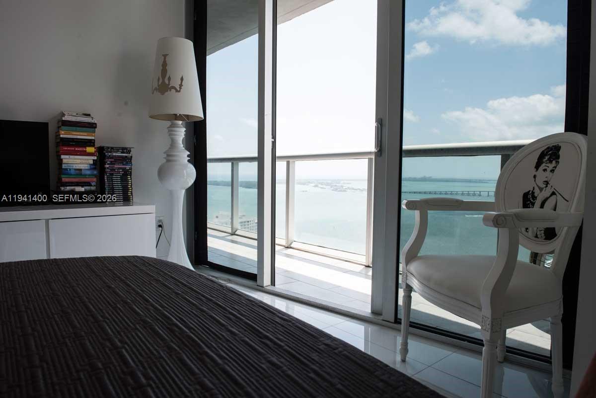 495 Brickell Avenue, Unit 3805 Miami, FL 33131 - Photo 12 of 18 a view of a balcony with furniture and a window