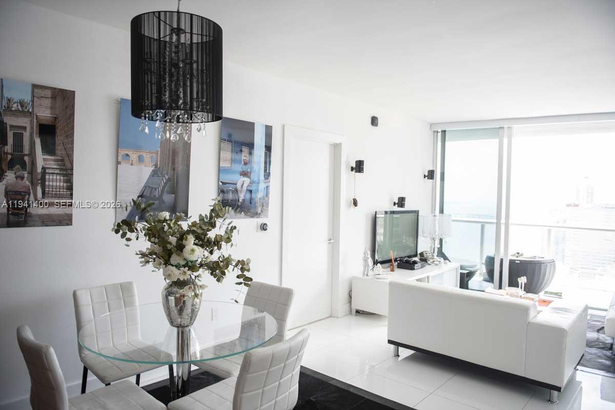 495 Brickell Avenue, Unit 3805 Miami, FL 33131 - Photo 2 of 18 a living room with furniture and wooden floor