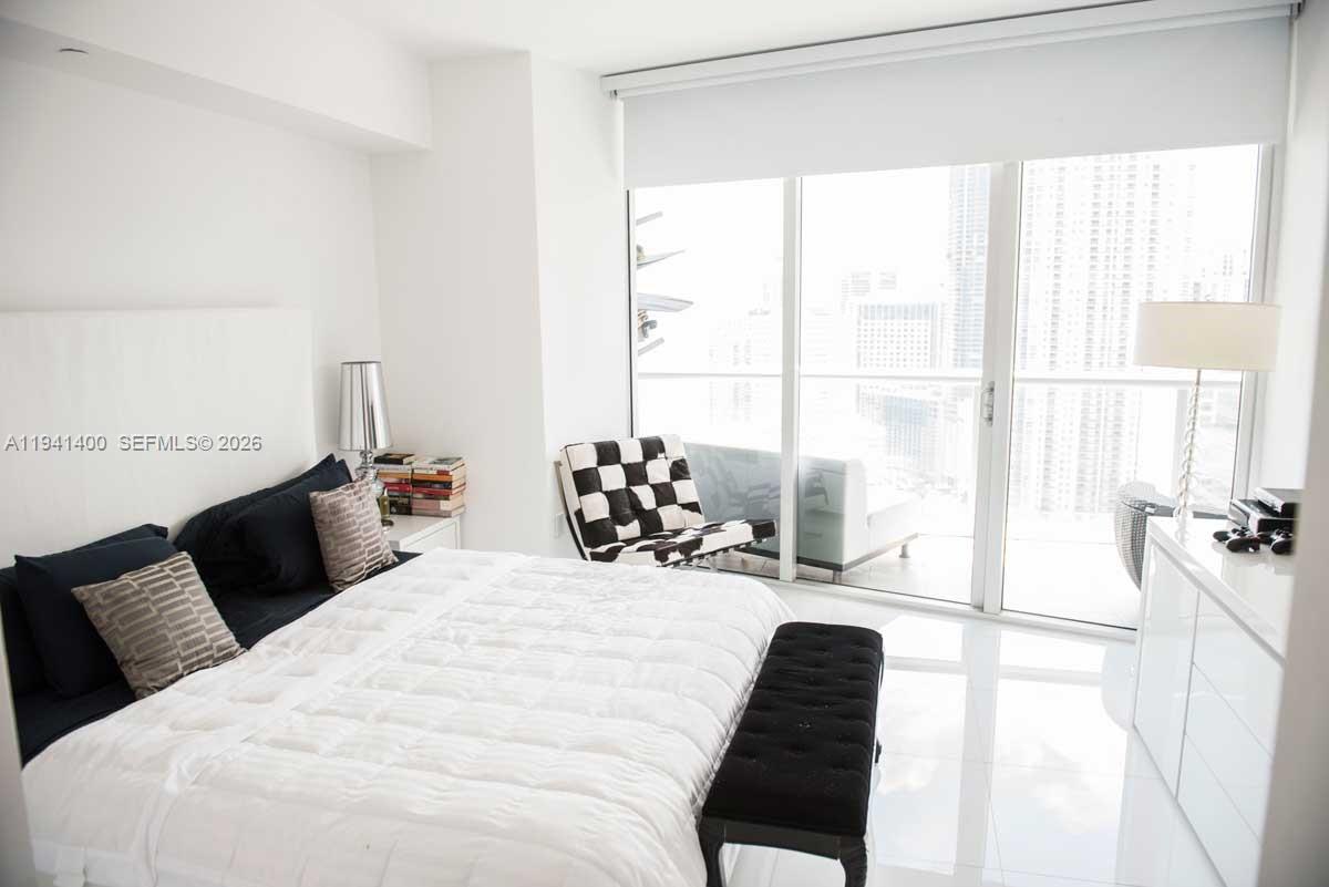 495 Brickell Avenue, Unit 3805 Miami, FL 33131 - Photo 6 of 18 a bedroom with a bed and a large window