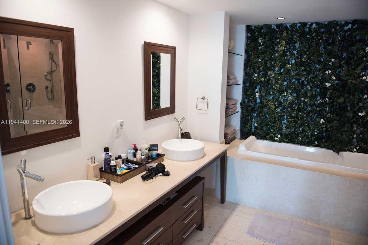 495 Brickell Avenue, Unit 3805 Miami, FL 33131 - Photo 8 of 18 a bathroom with a sink and a mirror