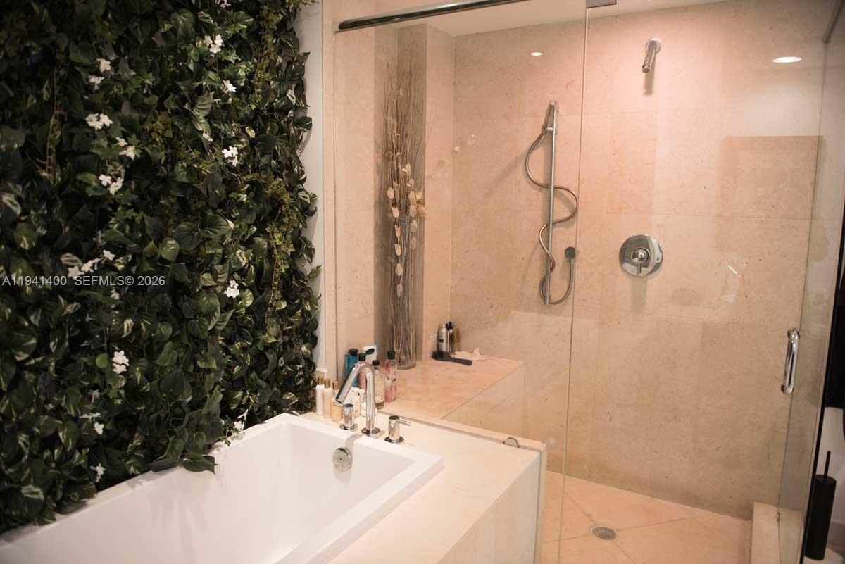 495 Brickell Avenue, Unit 3805 Miami, FL 33131 - Photo 10 of 18 a bathroom with a sink and a mirror