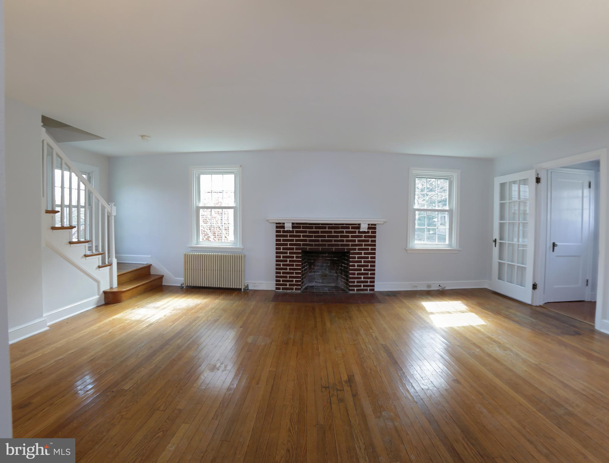 606 Pleasure Road Lancaster, PA 17601 - Photo 18 of 42 Living room with wood fireplace hardwood floors