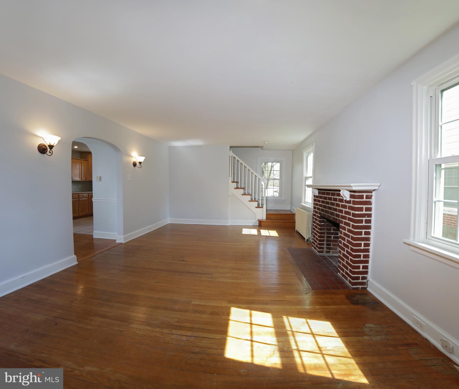 606 Pleasure Road Lancaster, PA 17601 - Photo 19 of 42 Living room with wood fireplace hardwood floors