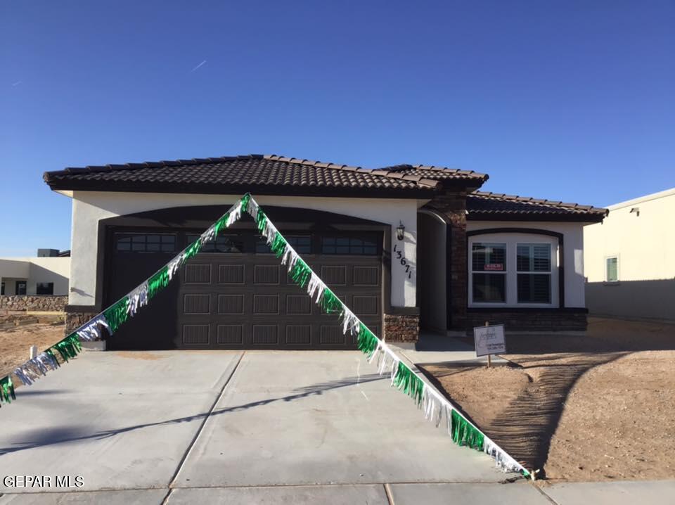 a front view of a house with garage