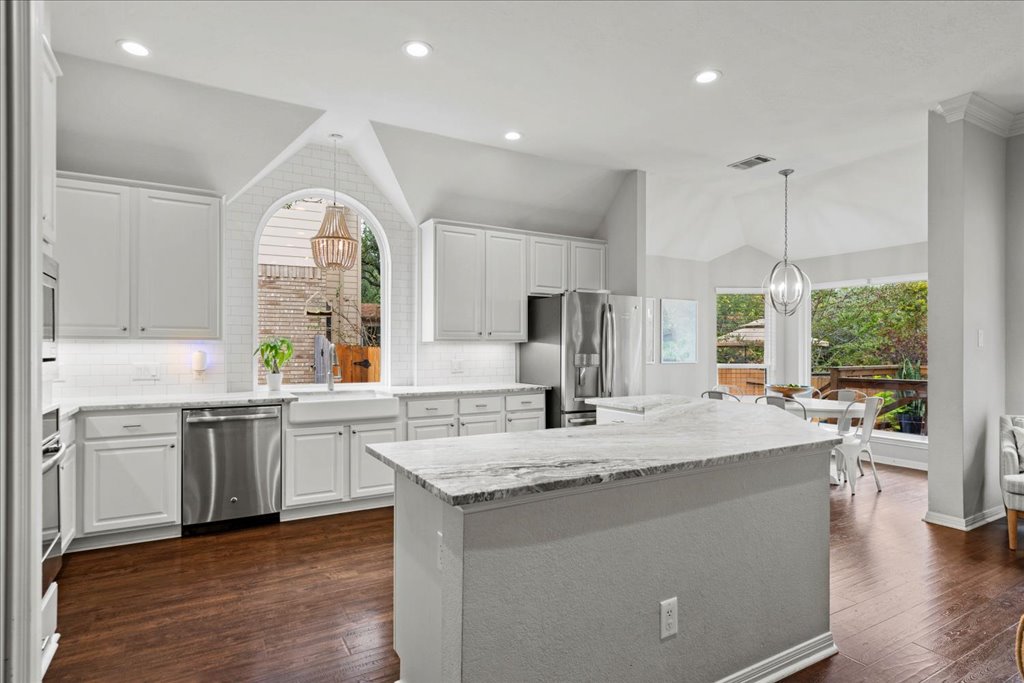 10744 Chestnut Ridge Road Austin, TX 78726 - Photo 12 of 34 Kitchen features large center island, stainless appliances, gas cooking, and quartzite countertops.