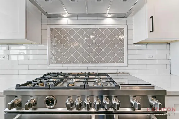 a stove top oven sitting inside of a kitchen