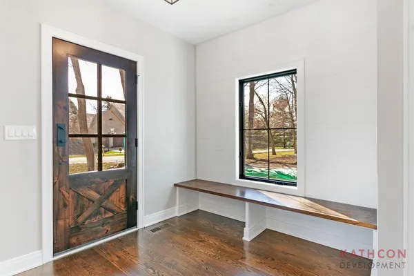 a workspace with wooden floor and a window