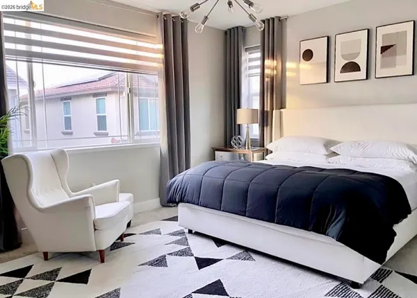 a bedroom with a large bed and a window