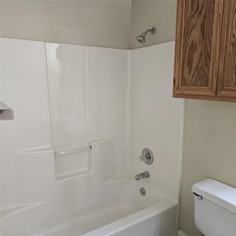7905 Flowertree Court Fort Worth, TX 76137 - Photo 13 of 17 a white bath tub with a white toilet