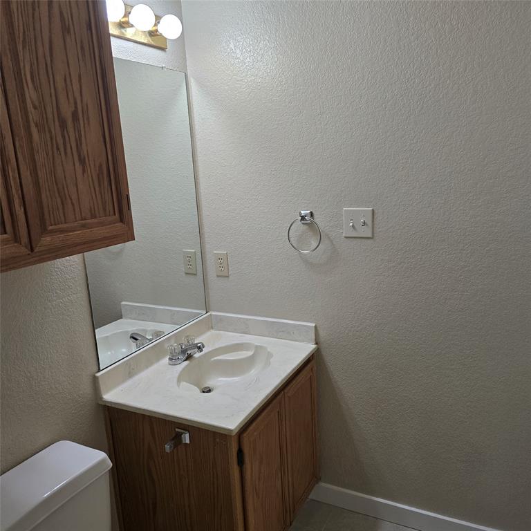 7905 Flowertree Court Fort Worth, TX 76137 - Photo 14 of 17 a bathroom with a sink a vanity and a mirror