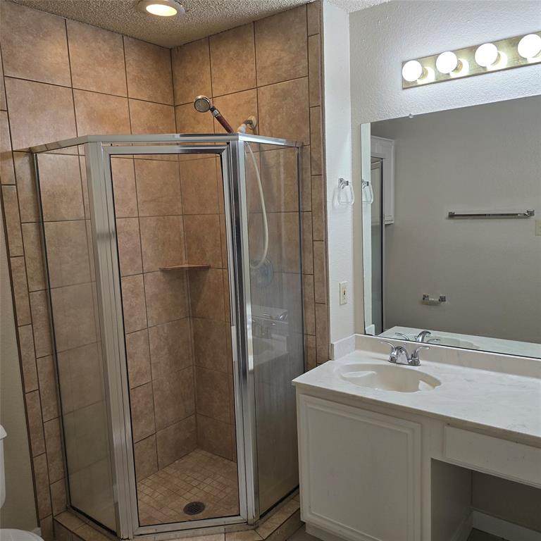 7905 Flowertree Court Fort Worth, TX 76137 - Photo 4 of 17 a bathroom with a shower and a sink