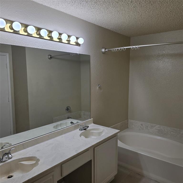 7905 Flowertree Court Fort Worth, TX 76137 - Photo 5 of 17 a bathroom with a sink and a mirror