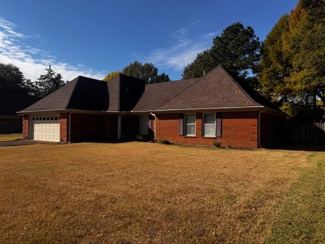 8460 Buckhurst Road Memphis, TN 38016 - Photo 3 of 19 a front view of house with yard and trees in the background