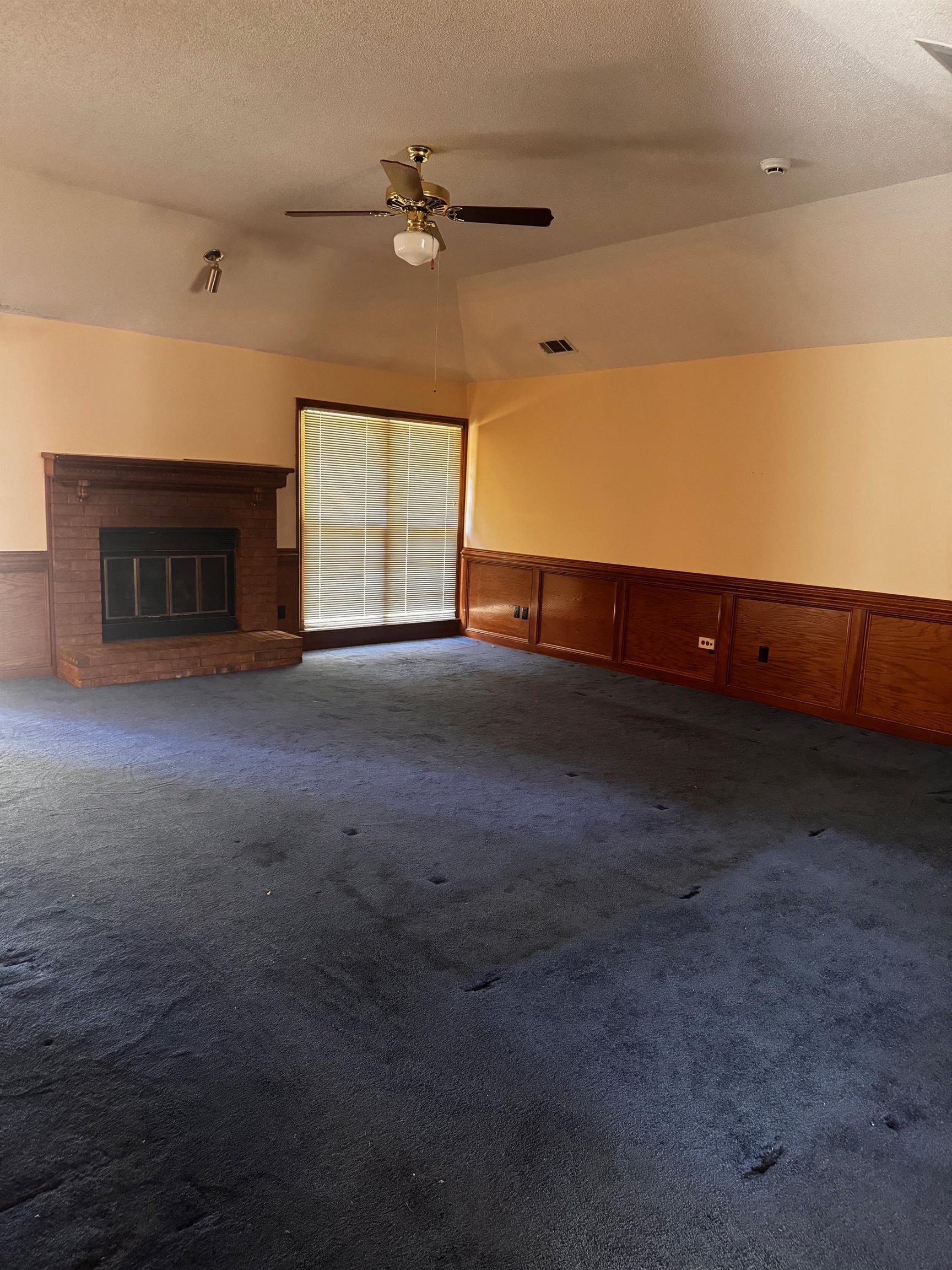 8460 Buckhurst Road Memphis, TN 38016 - Photo 8 of 19 a view of an empty room with a fireplace
