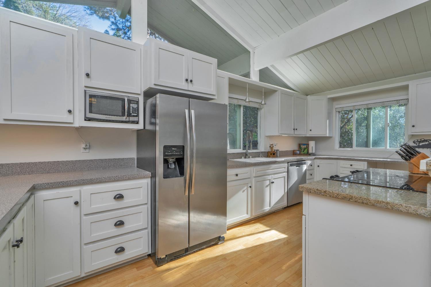 2869 Cascade Trail Cool, CA 95614 - Photo 13 of 80 a kitchen with granite countertop cabinets and stainless steel appliances