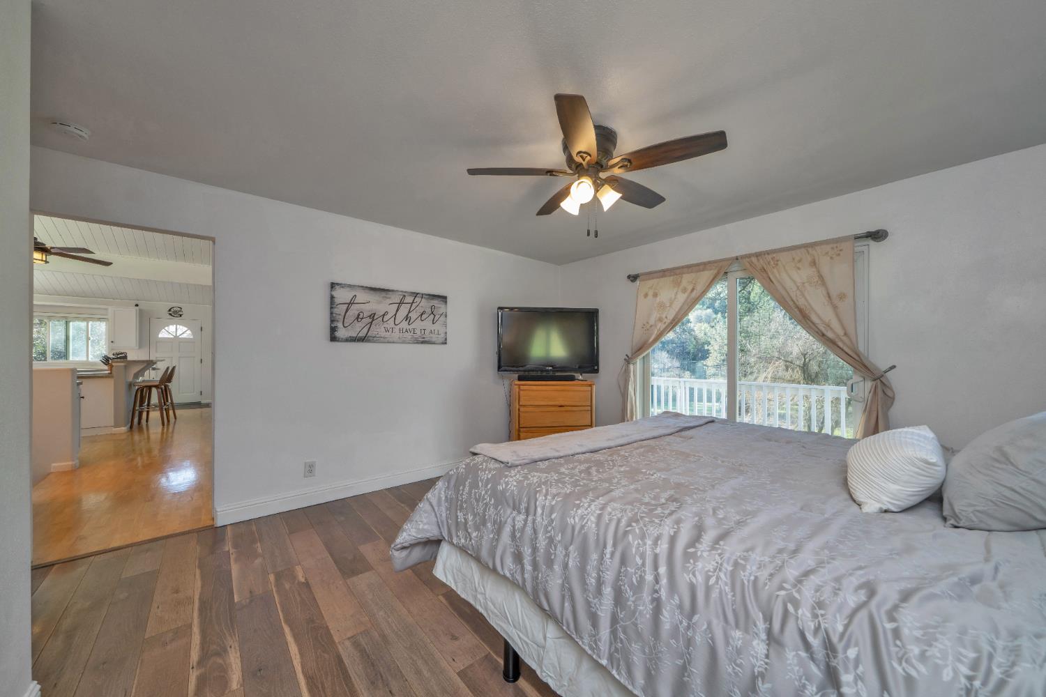 2869 Cascade Trail Cool, CA 95614 - Photo 22 of 80 a bedroom with a large bed and a large window