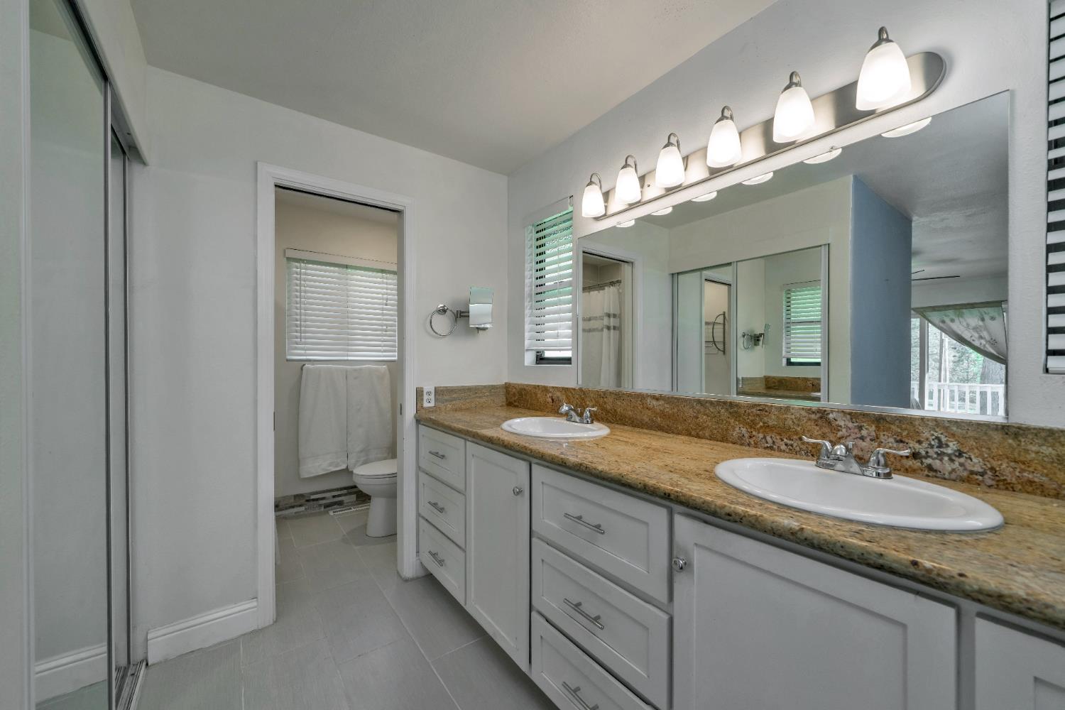 2869 Cascade Trail Cool, CA 95614 - Photo 23 of 80 a bathroom with double vanity sink and a mirror